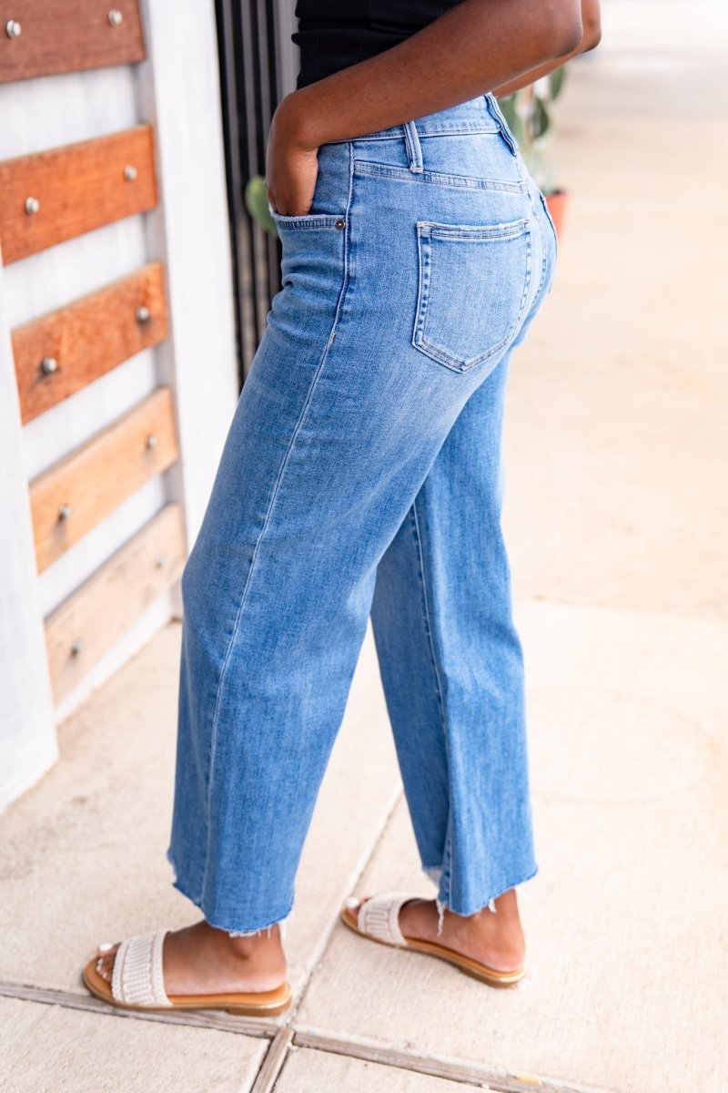 Person wearing blue jeans with a blurred background