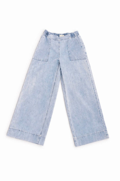 Light blue denim pants on a white background