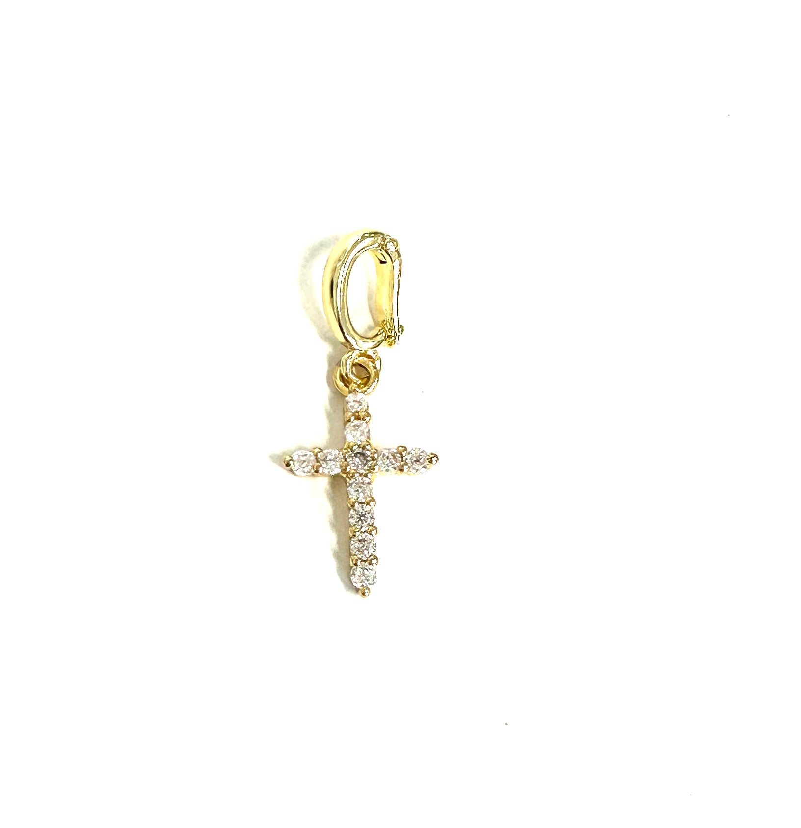 Gold cross pendant with diamonds on a white background
