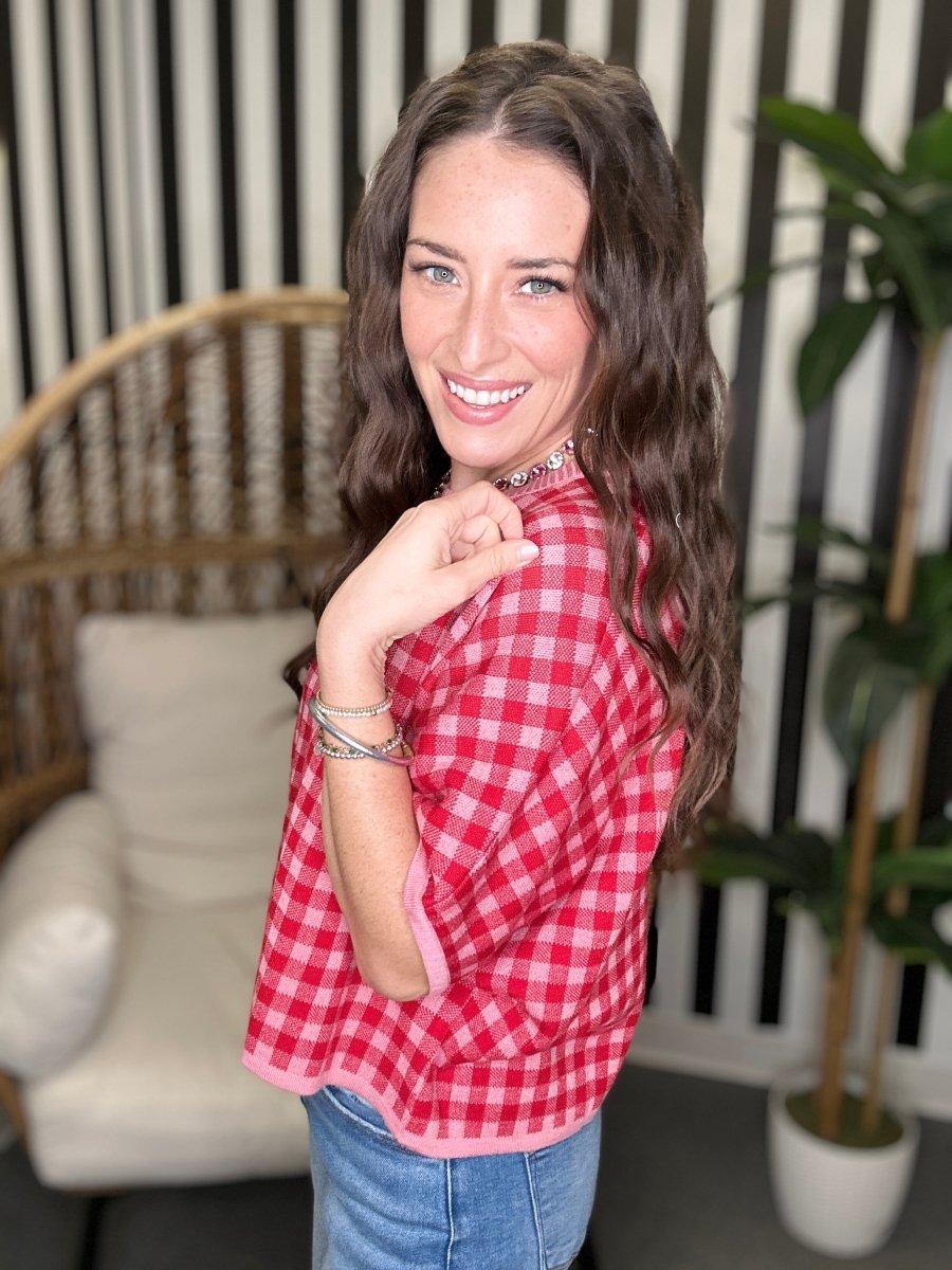 Woman wearing a red plaid shirt in a home setting