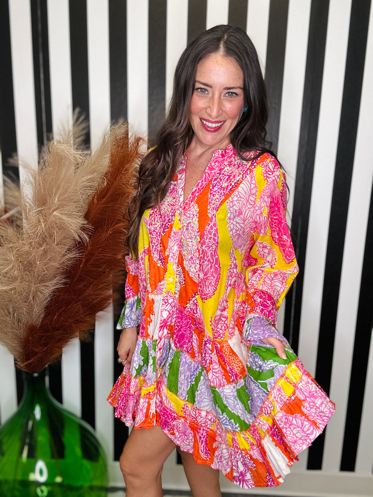 woman standing in a colorful printed dress.