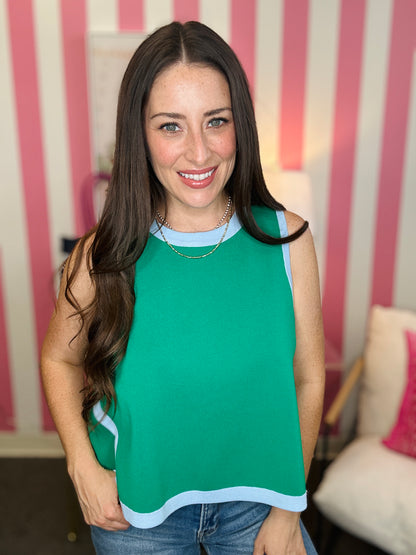 Woman wearing a green sleeveless top with a striped background