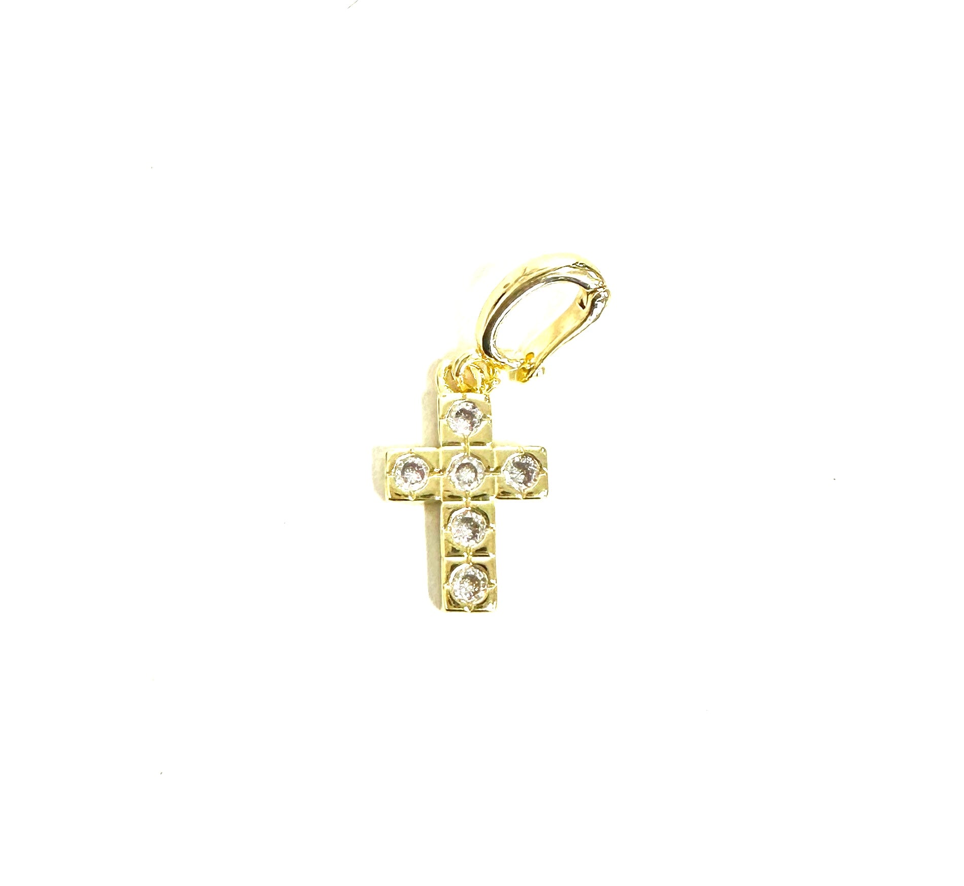 Gold cross pendant with embedded stones on a white background