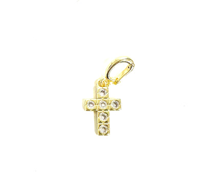 Gold cross pendant with embedded stones on a white background