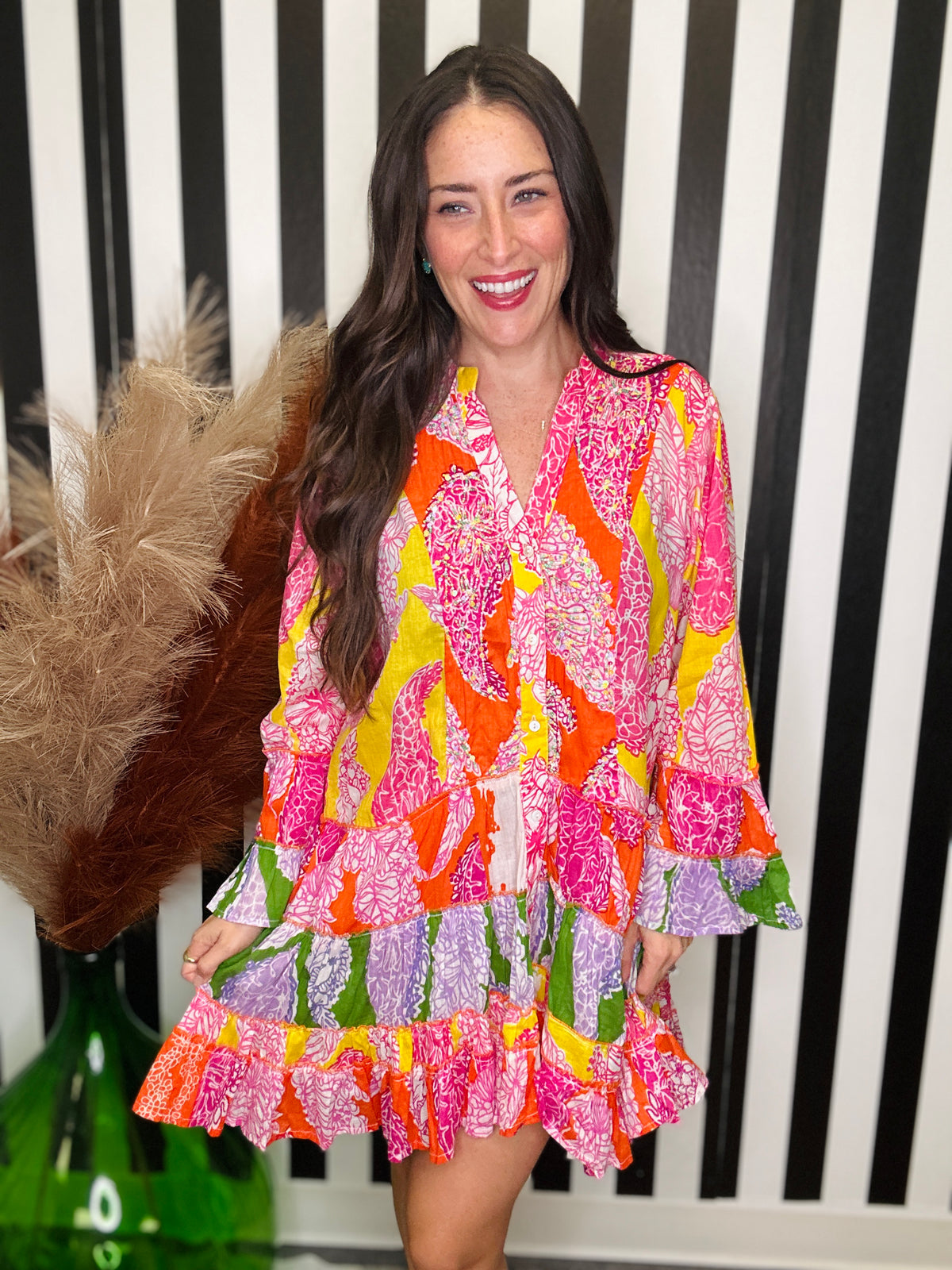 woman standing in a colorful printed dress.
