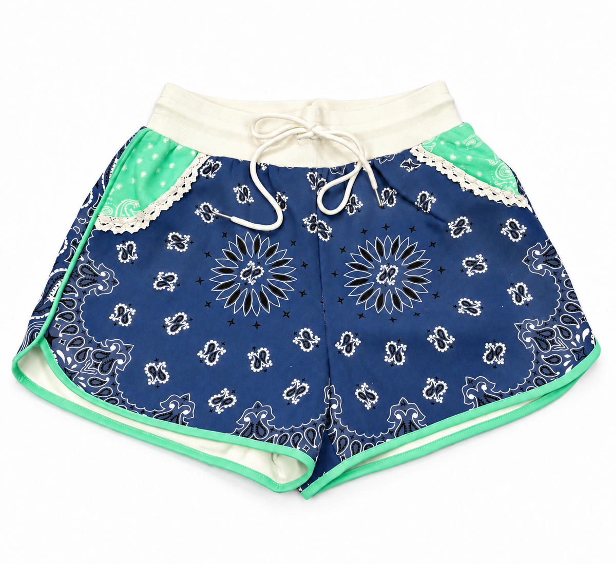 A pair of women's shorts featuring a navy blue bandana print, a white lace trim, a white drawstring waist, and mint green accents on the side panels and inner leg.