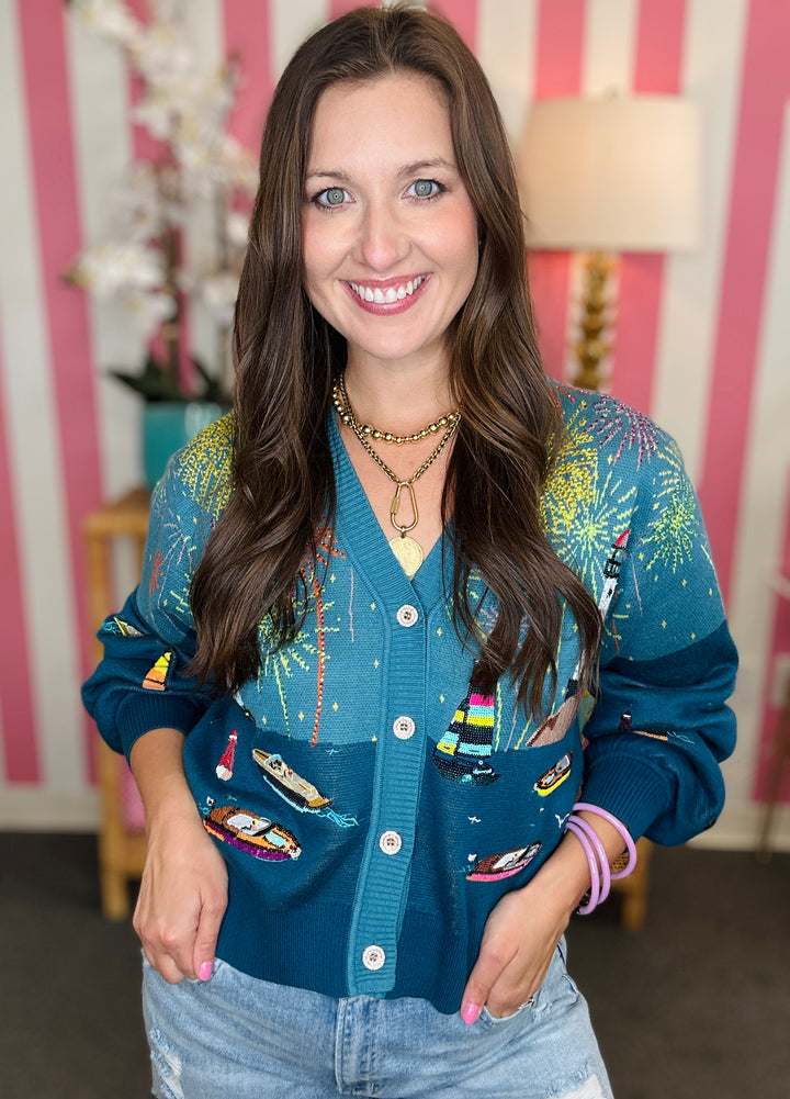 Woman wearing a colorful cardigan with a striped wall background
