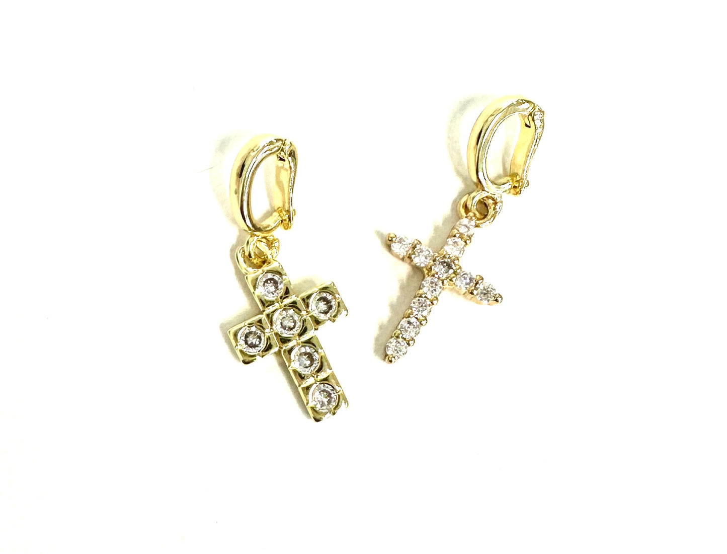 Gold cross and star-shaped earrings with clear stones on a white background