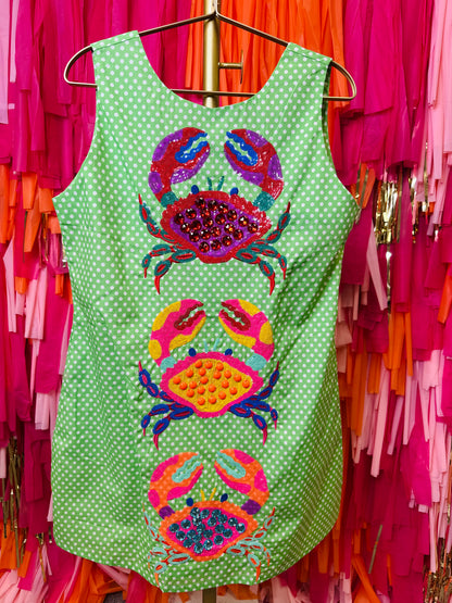 Green polka dot tank top with colorful crab designs on a colorful background