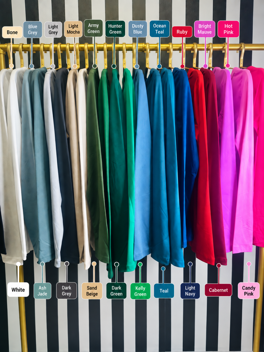 A clothing color chart display showing multiple long fabric swatches hanging on a gold rack against a black-and-white striped background, with labeled color names above and below each swatch.