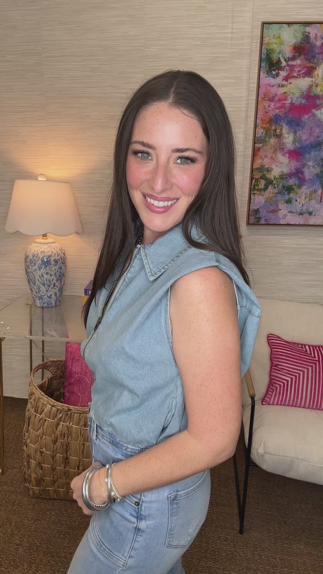 Woman wearing a denim outfit with a blurred indoor background