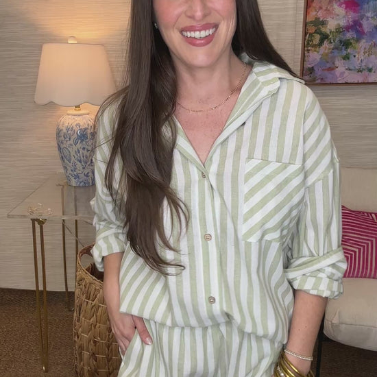 Woman wearing a striped outfit in a living room setting