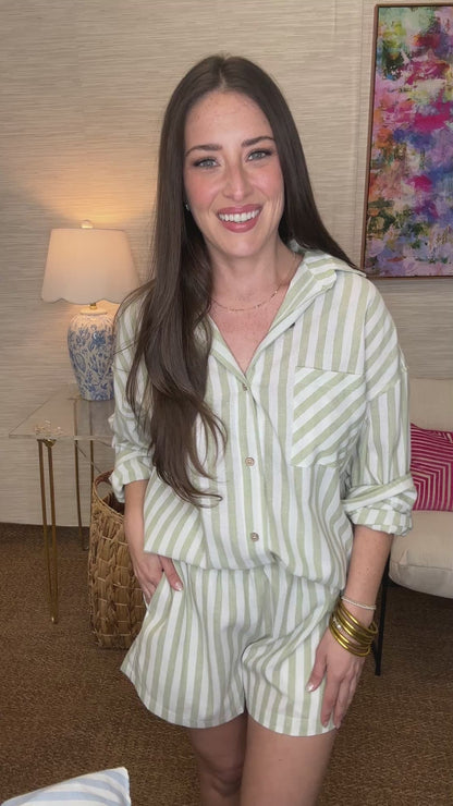Woman wearing a striped outfit in a living room setting