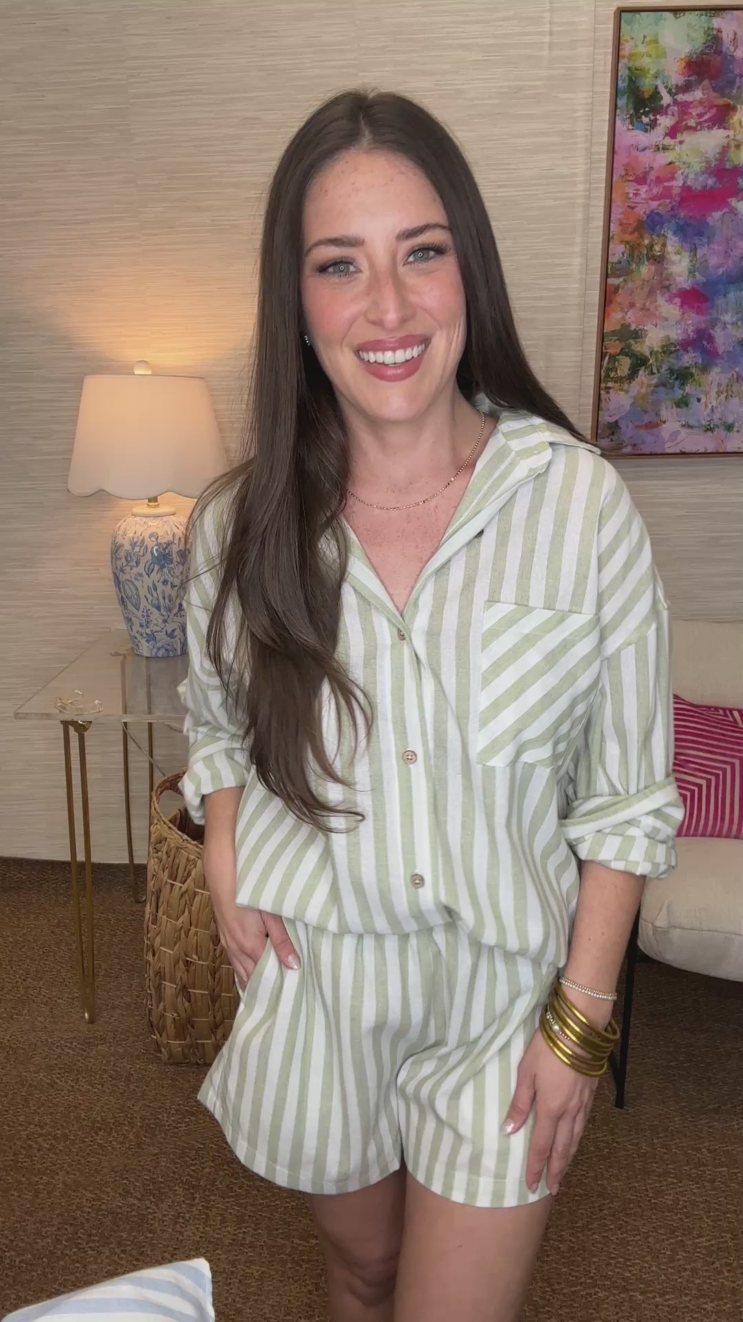 Woman wearing a striped outfit in a living room setting
