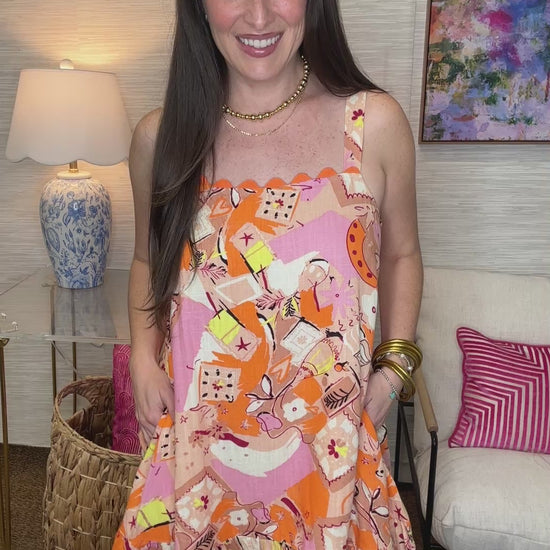Woman wearing a colorful patterned dress in a living room setting
