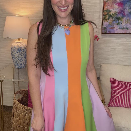 Woman wearing a colorful dress in a living room setting