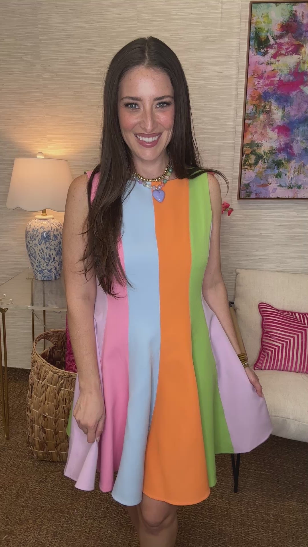 Woman wearing a colorful dress in a living room setting